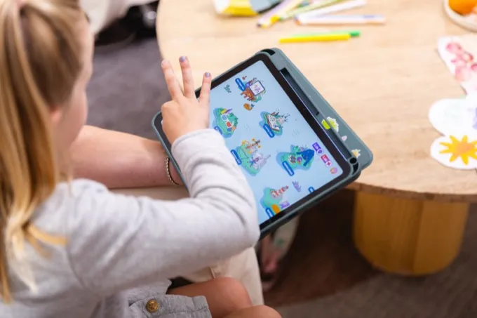 Girl drawing stickers on a tablet