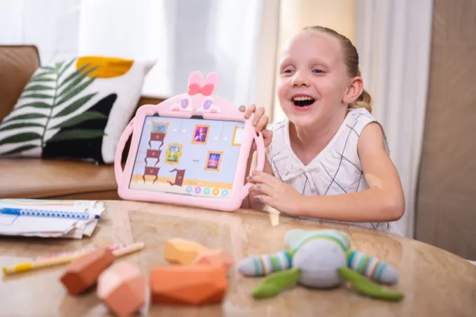 Girl showing her artwork on a tablet
