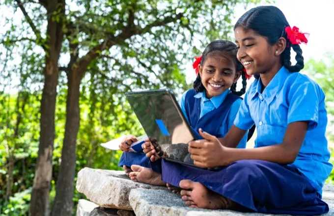 Students using a laptop outdoors